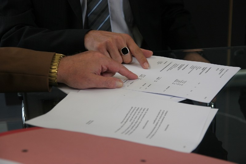 How to Get Signed to a Record Label - people looking over contracts