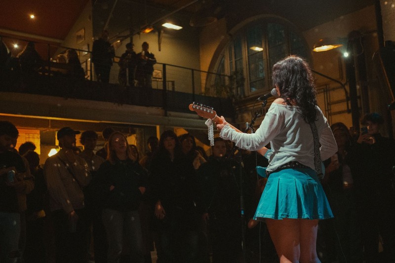 4 Steps to Secure Artist Interviews - artist performing live on stage