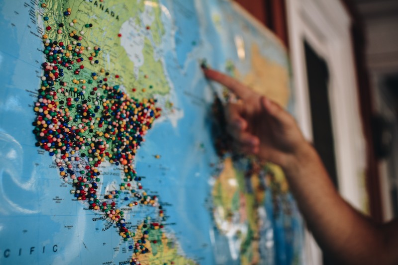 5 Easy Ways to Get DJing Gigs - person looking at world map