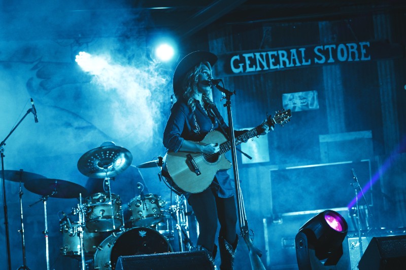10 Best Vocal Microphones to Power up Live Performances - performer singing on stage