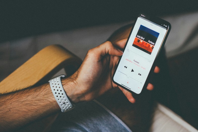How to Get Lyrics on Spotify, Apple Music & More - Person using Apple Music on mobile