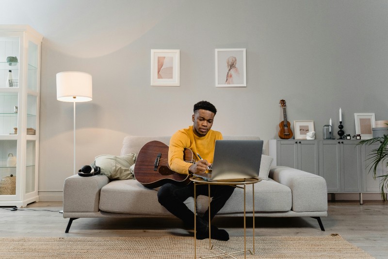 What Does Owning Your Masters Mean? -Musician songwriting at home on the sofa